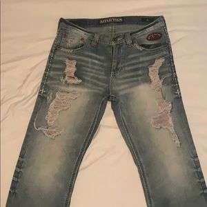 Affliction jeans made to look distressed.